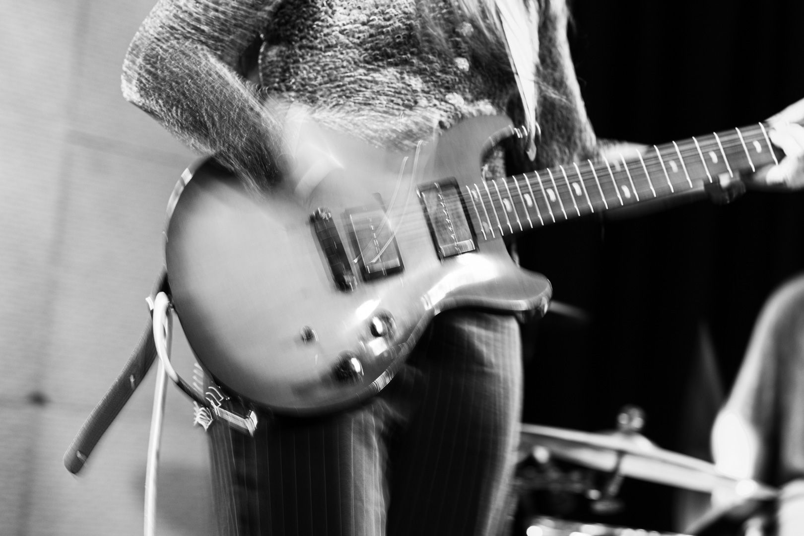 A black and white photo of a person playing a guitar