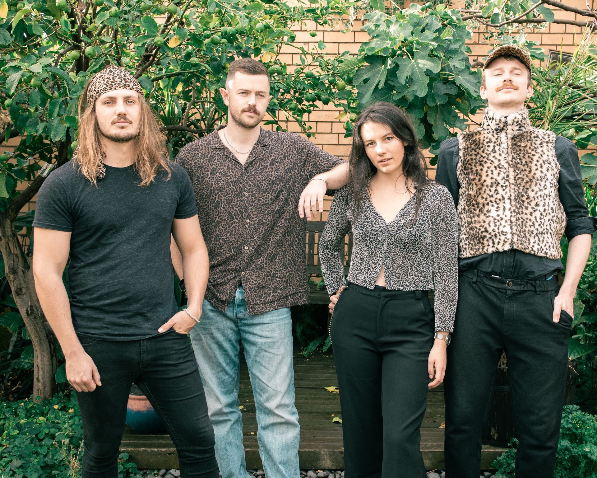A group of people standing next to each other in front of a brick building.