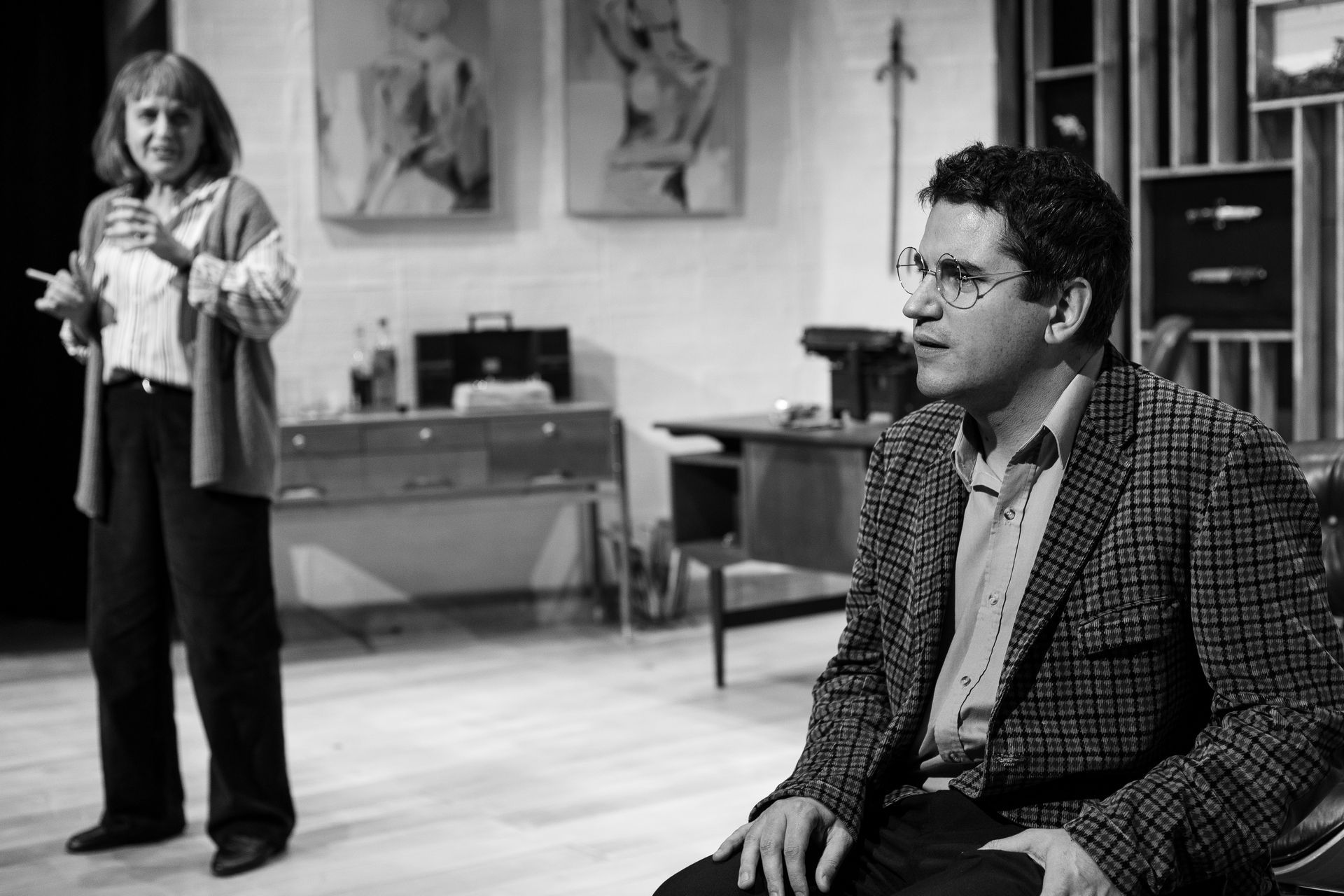 A black and white photo of a man and woman in a living room