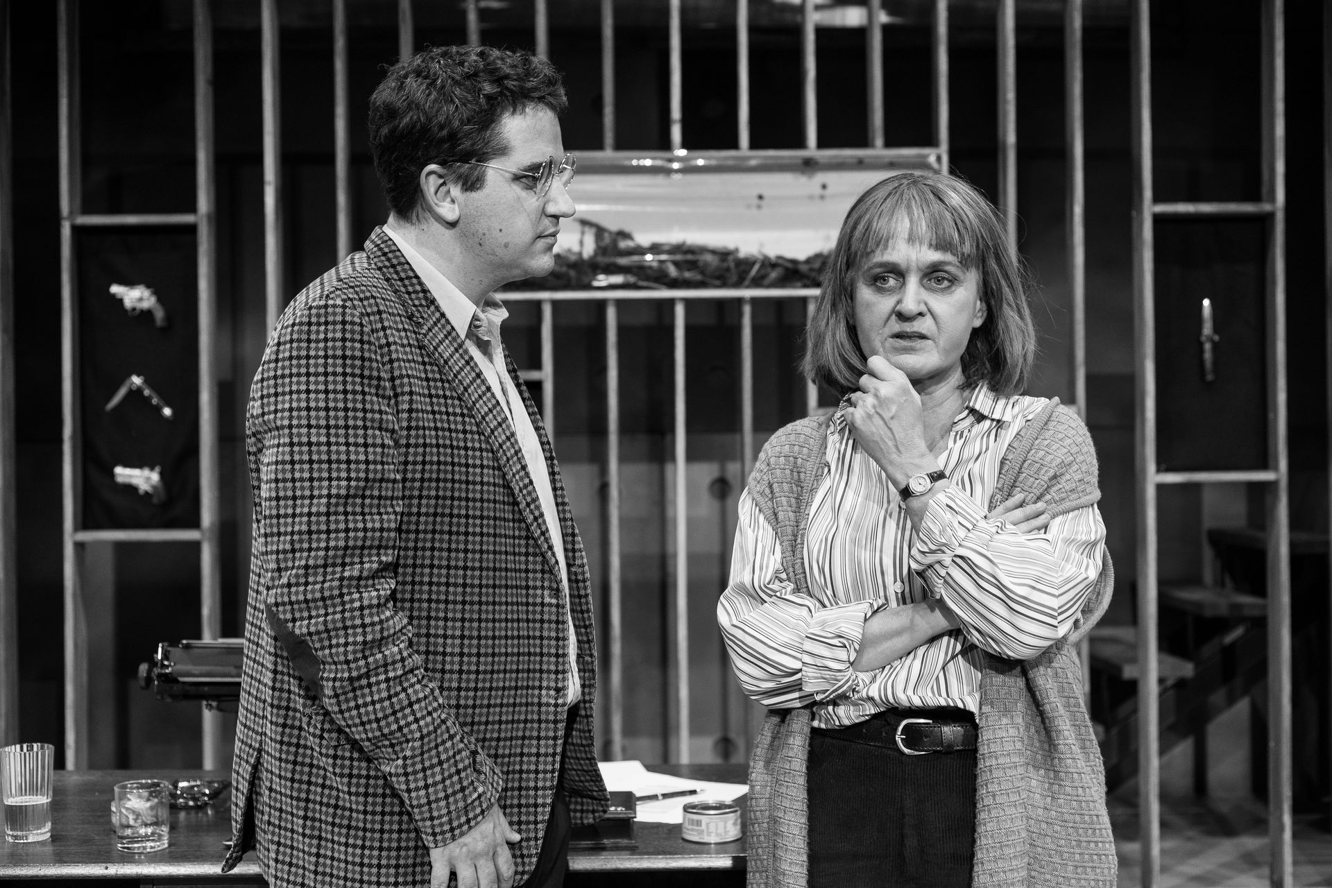 A man and a woman are standing next to each other in a black and white photo.