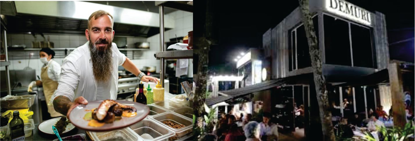 Un hombre con barba sostiene un plato de comida frente a un restaurante.
