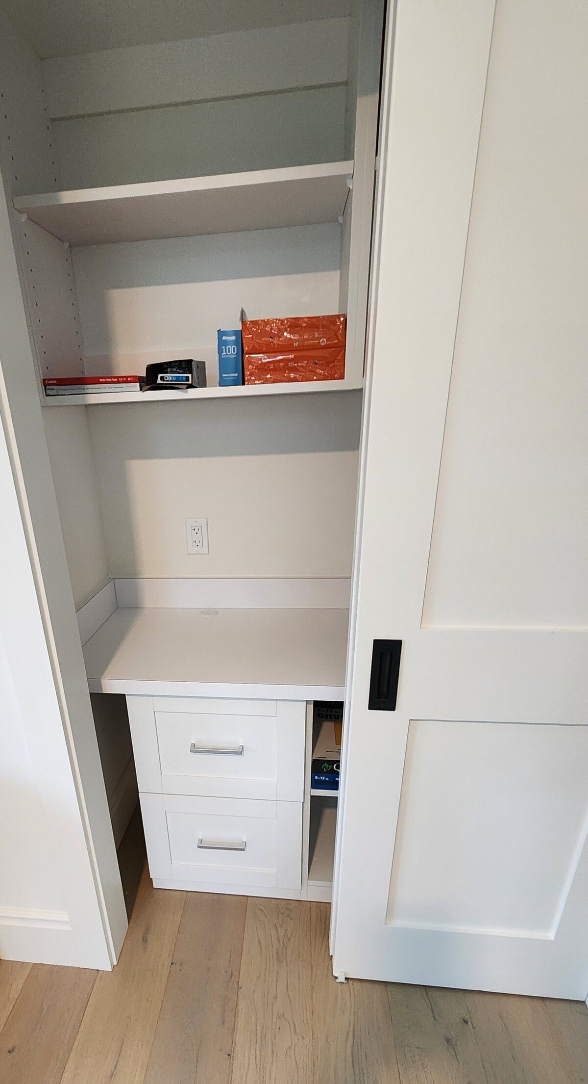 A closet with a desk and shelves in it