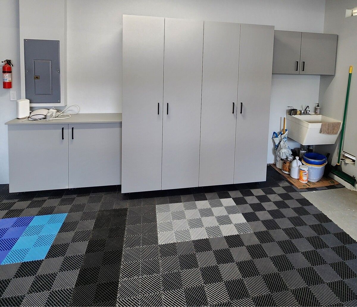 A garage with lots of cabinets and a checkered floor