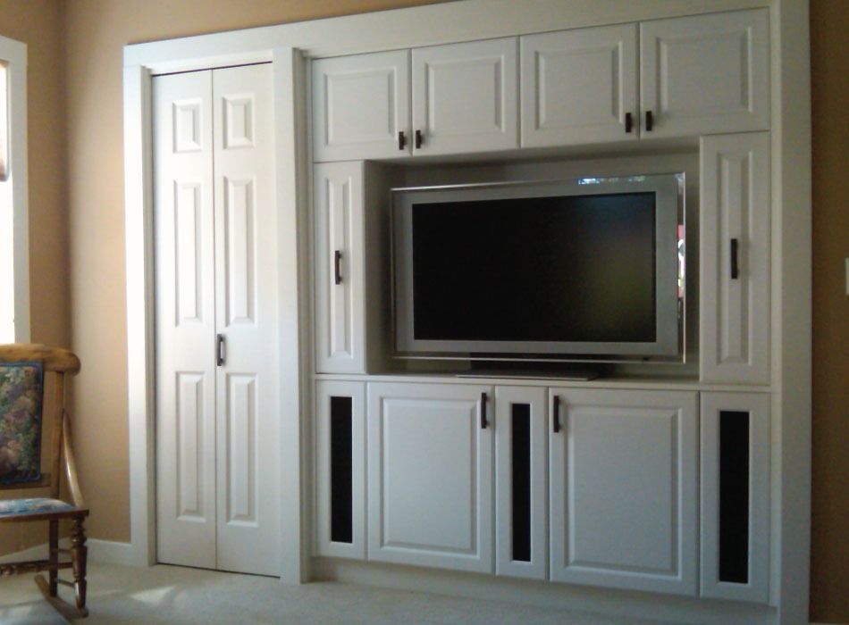 A living room with white cabinets and a flat screen tv