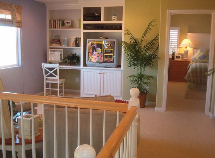 A living room with a flat screen tv on the wall