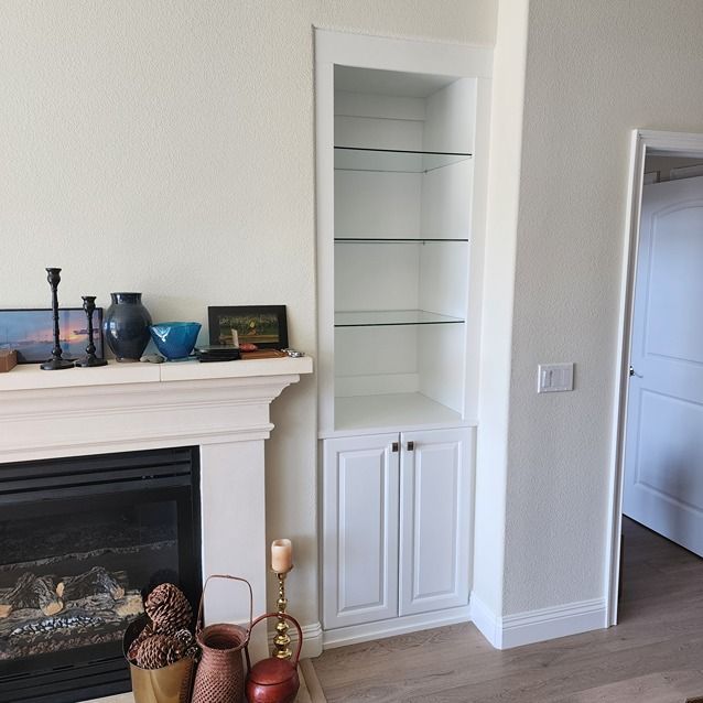 A living room with a fireplace and a bookshelf