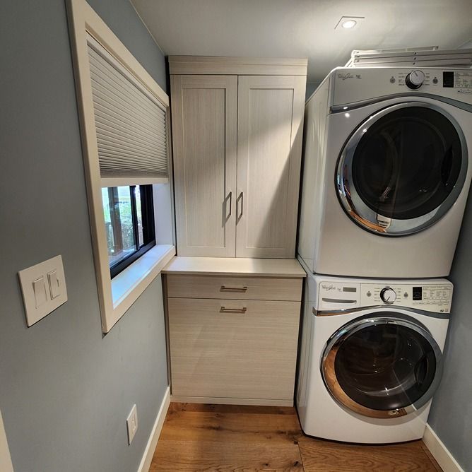 A laundry room with a washer and dryer stacked on top of each other