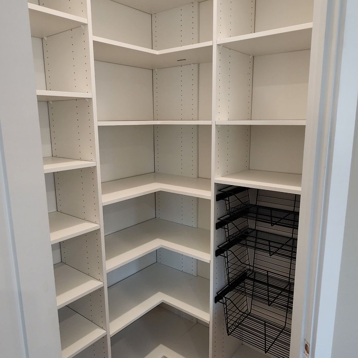 A walk in closet with lots of shelves and baskets