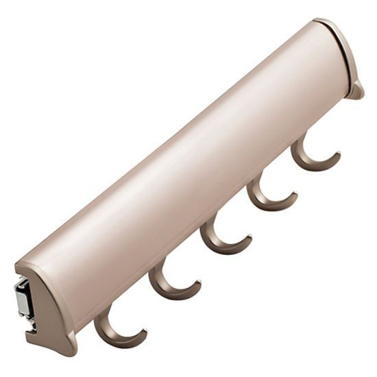 A row of hooks on a white surface