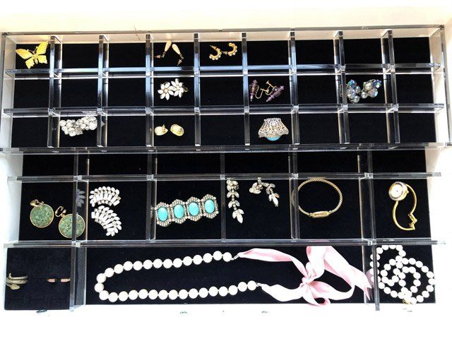 A display case filled with jewelry including a necklace and earrings