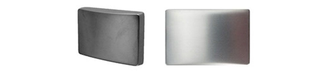 A black and a silver object are sitting next to each other on a white background.