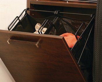 A laundry basket in a drawer with clothes in it
