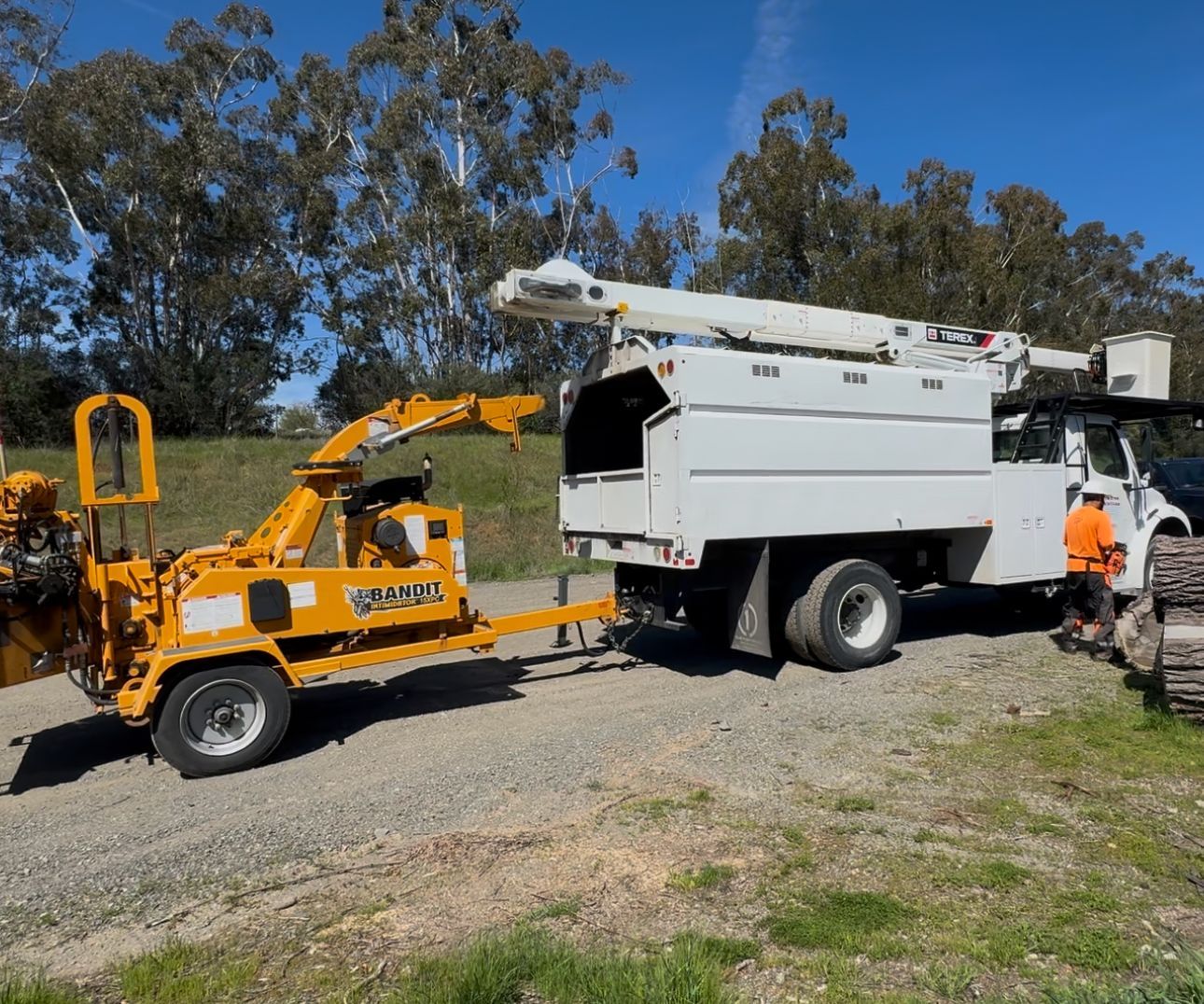 A white truck with a yellow trailer attached to it