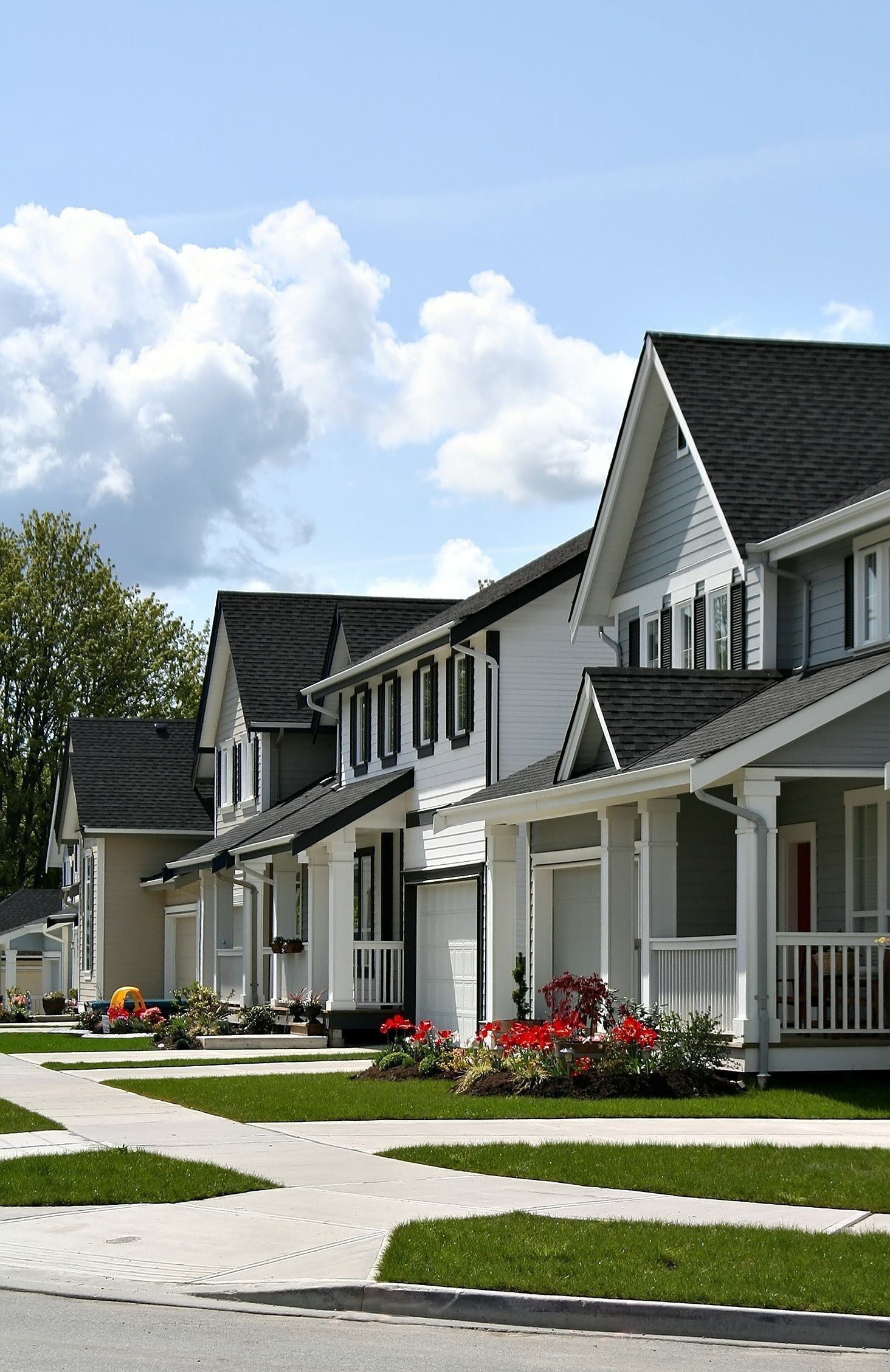 A row of houses on a sunny day with a blue sky in the background