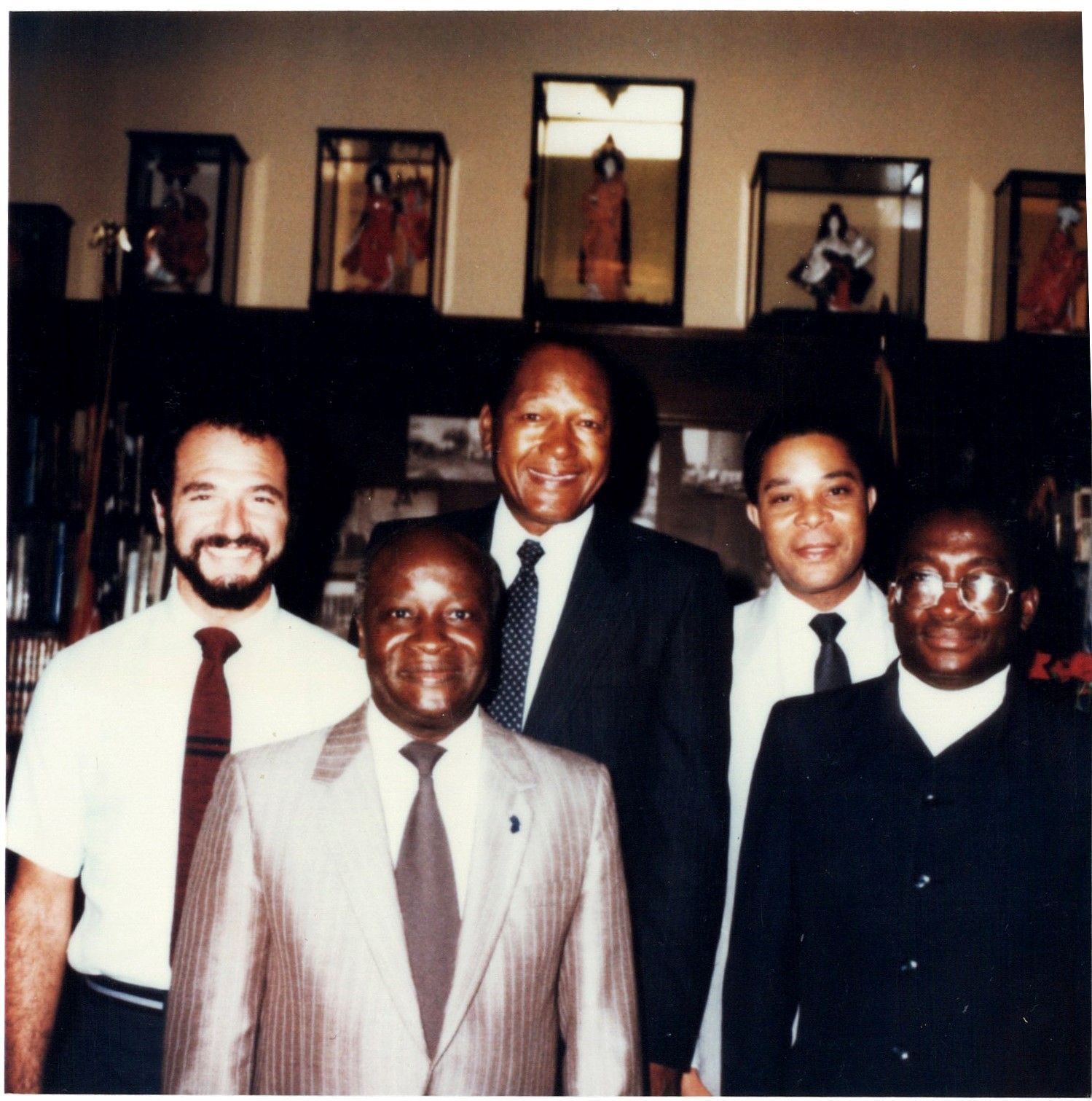 A group of men in suits and ties pose for a photo