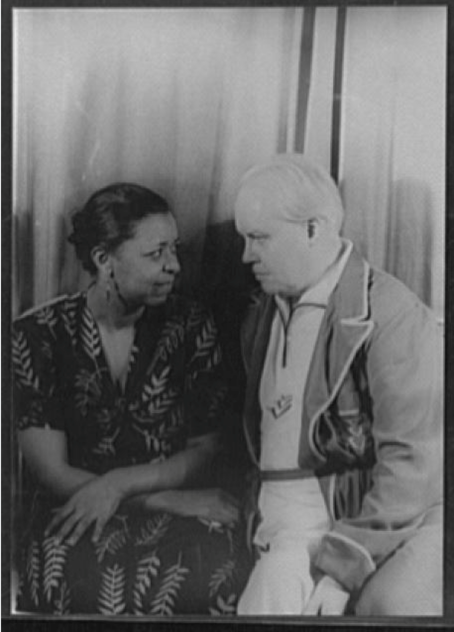 a man and a woman are sitting next to each other in a black and white photo .