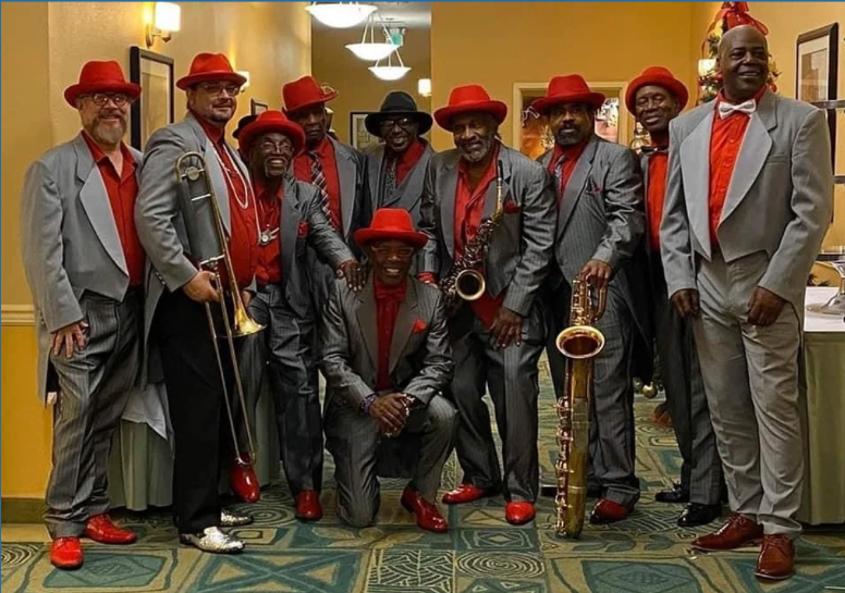 A group of men in suits and red hats are posing for a picture