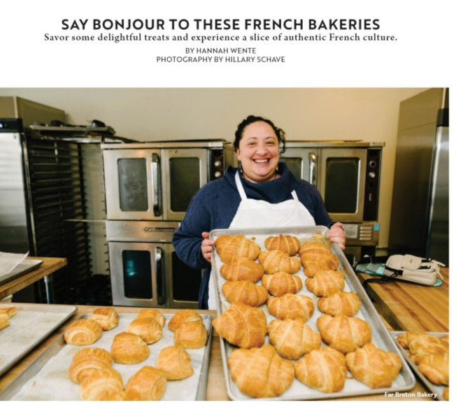 A woman is holding a tray of croissants in front of a sign that says say bonjour to these french bakeries