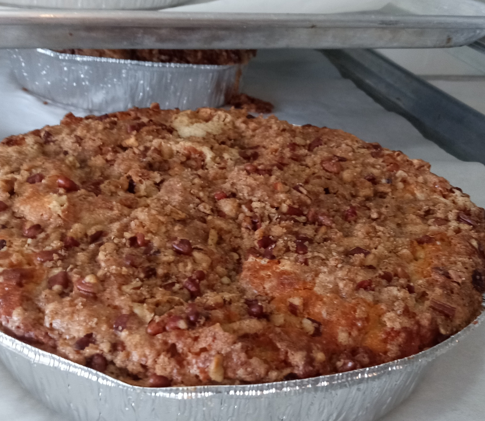 A close up of a pie in a tin foil pan