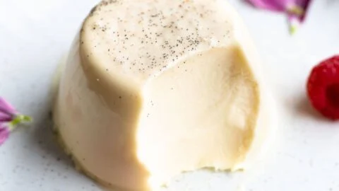 A close up of a dessert with a bite taken out of it on a plate.