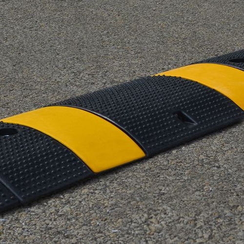 Black line painting machine applying a fresh stripe on a paved surface. Sunny outdoor setting.