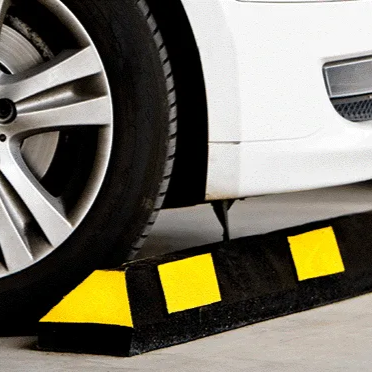 Black line painting machine applying a fresh stripe on a paved surface. Sunny outdoor setting.