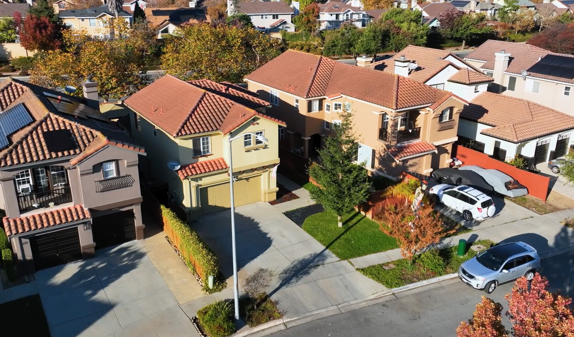 A large house with a slate roof and two garages