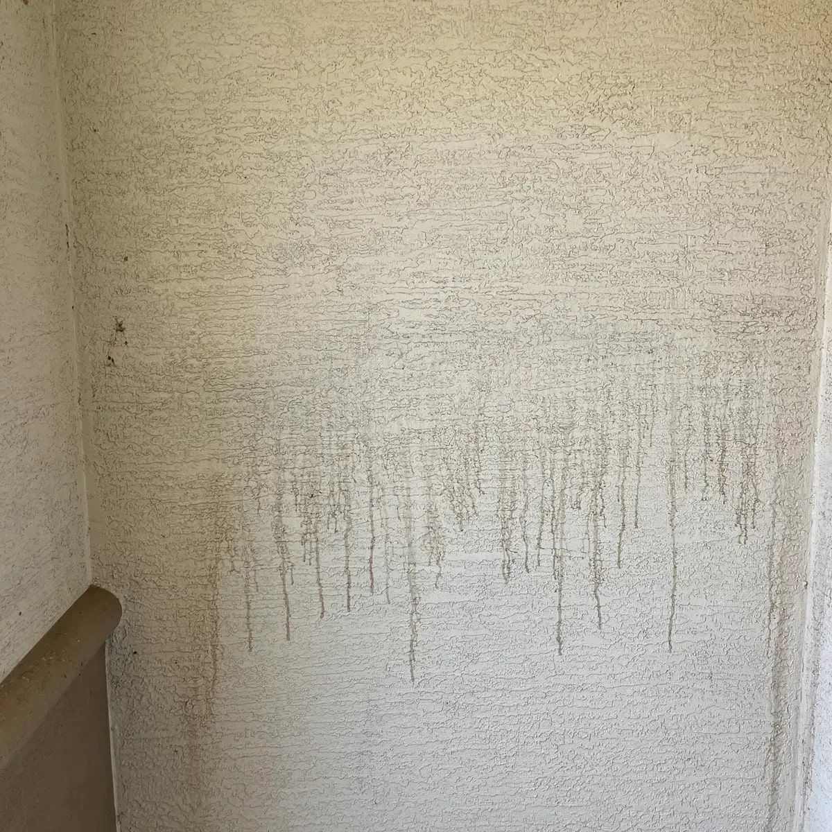 A dirty wall with a lot of stains on it.