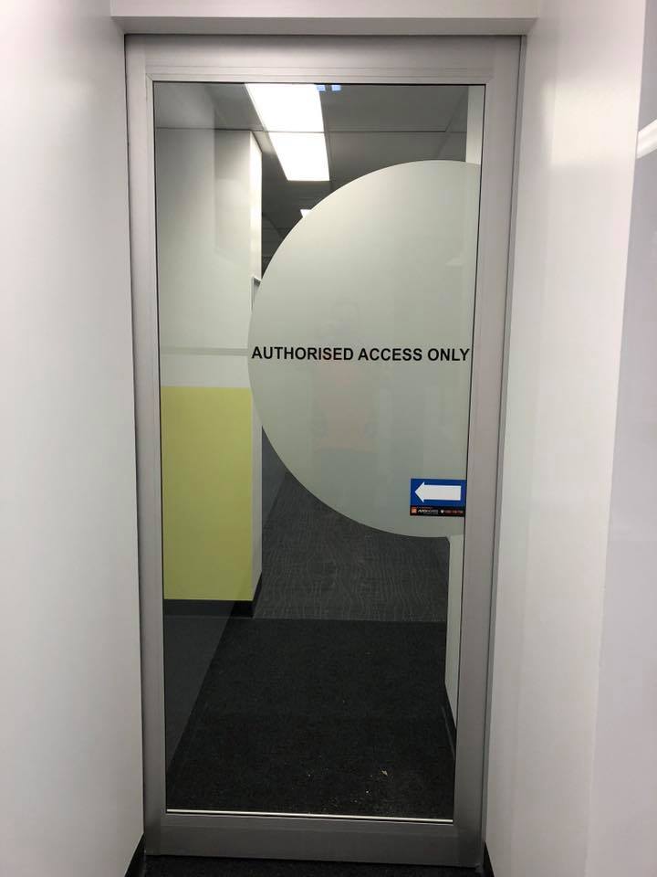 Office Building Glass Door With Signage — Solarmaster Brisbane in Murarrie, QLD
