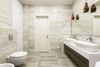 A bathroom with two sinks , a toilet , and a mirror.