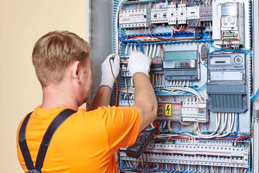 An Electrician is Repairing an Electrical Panel — Level 2 Electrician in Dubbo NSW