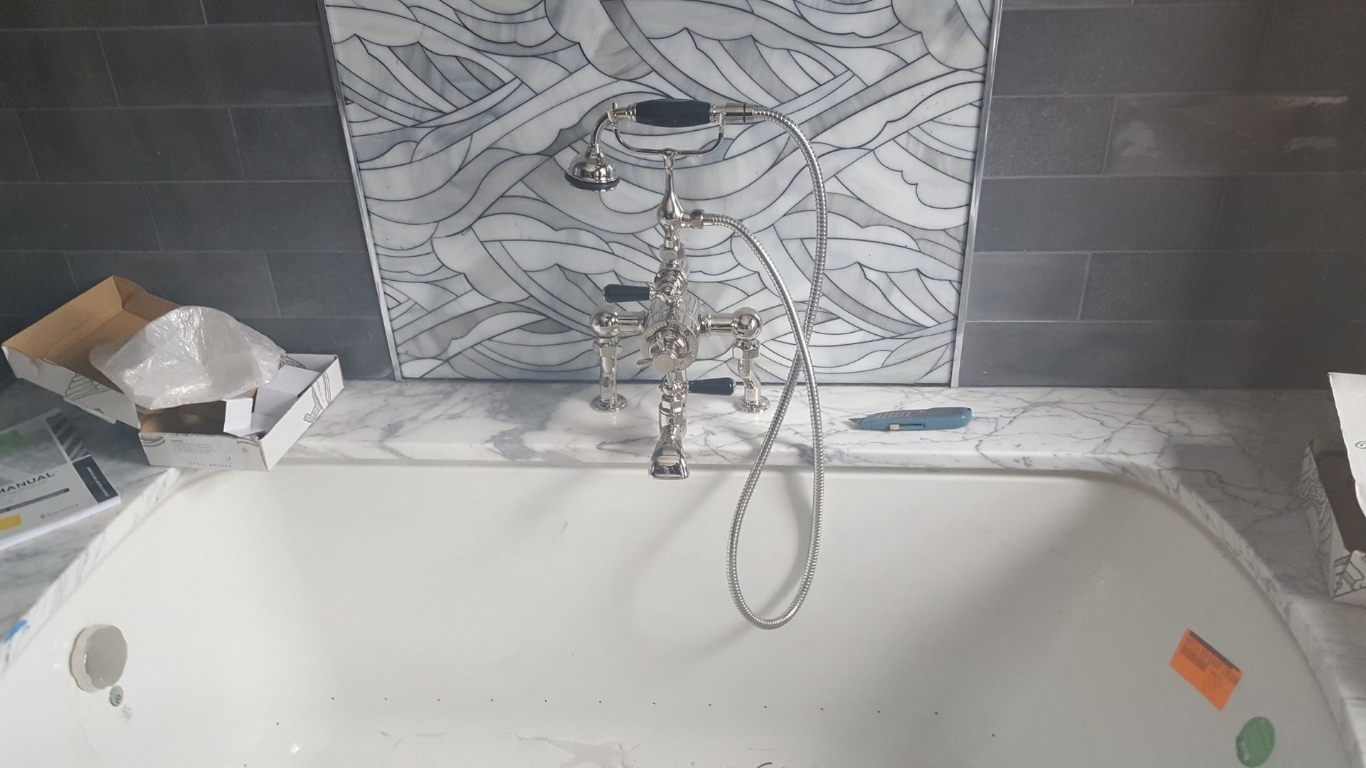 A bathtub with a shower head attached to it in a bathroom.