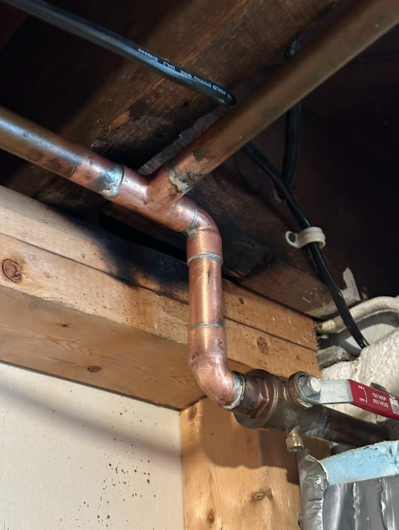 A close up of a copper pipe in a room