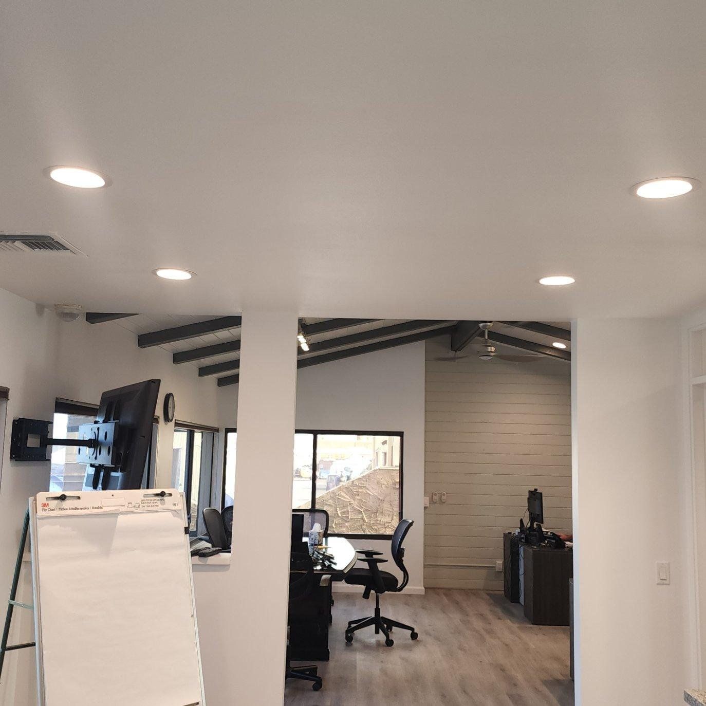 A room with a white board and a chair in it