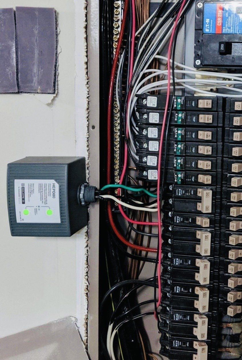 A close up of a electrical panel with a device attached to it