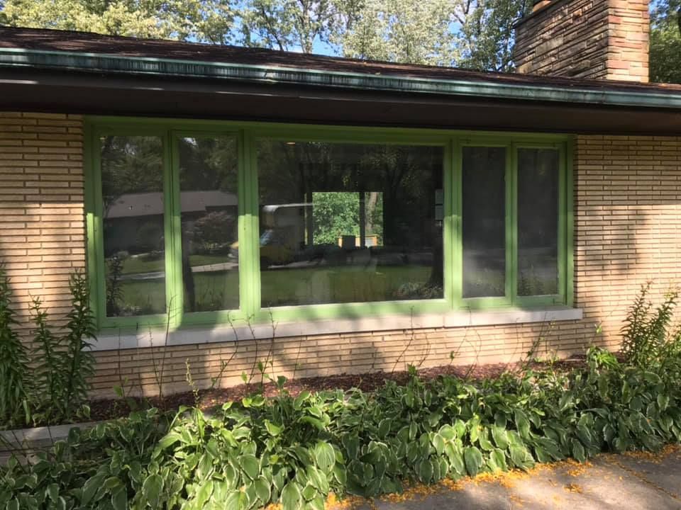 A house with a green window on the front of it.