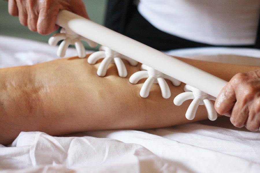 a person is getting a massage on their leg with a white stick .