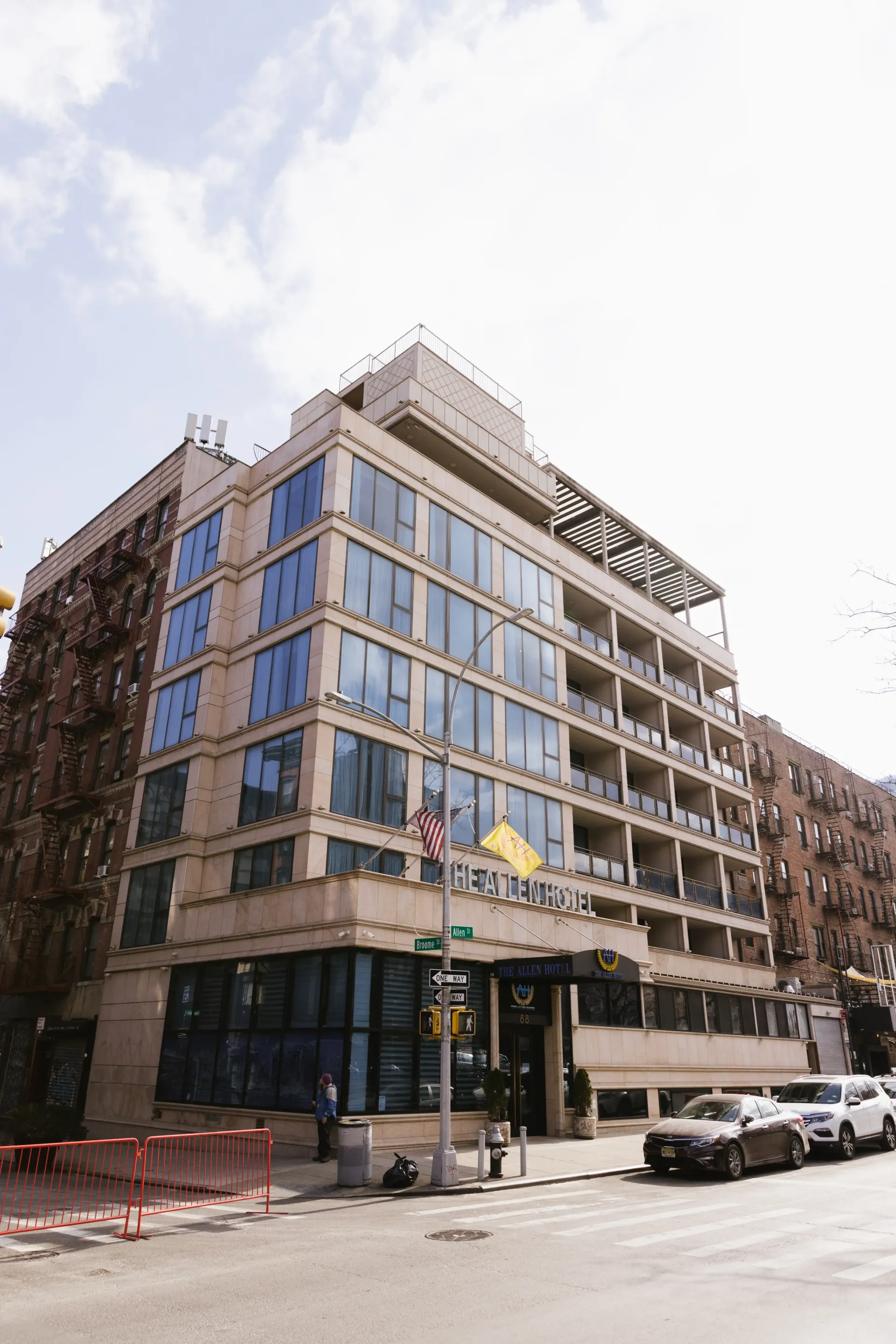 Modern building with blue glass windows, street, cars, and a clear sky.