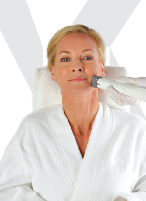 Woman looking at her skin in the mirror