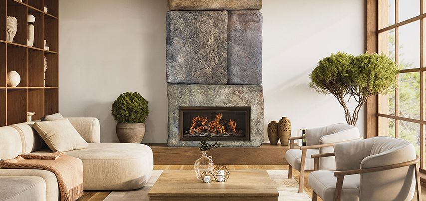 Living room with stone fireplace, sofas, chairs, and large window with tree.