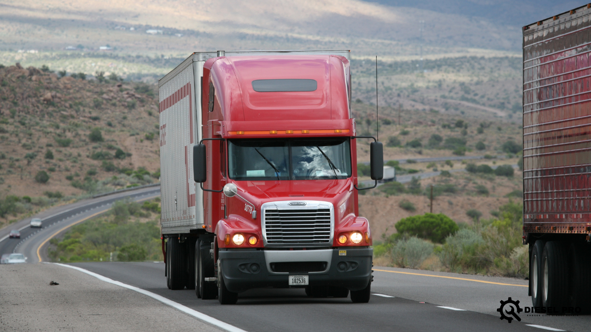 A red semi truck is driving down a snowy highway in Colorado.