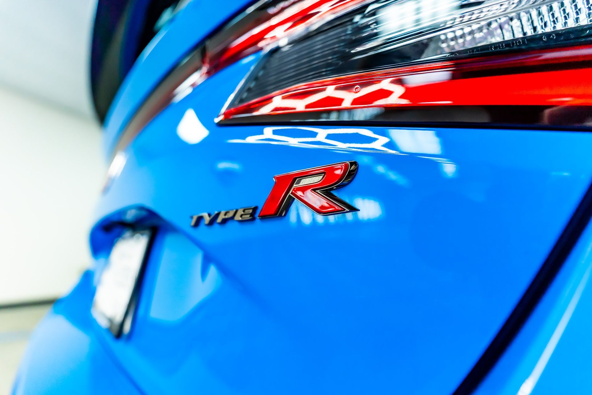 A silver suv is parked on the side of a road.