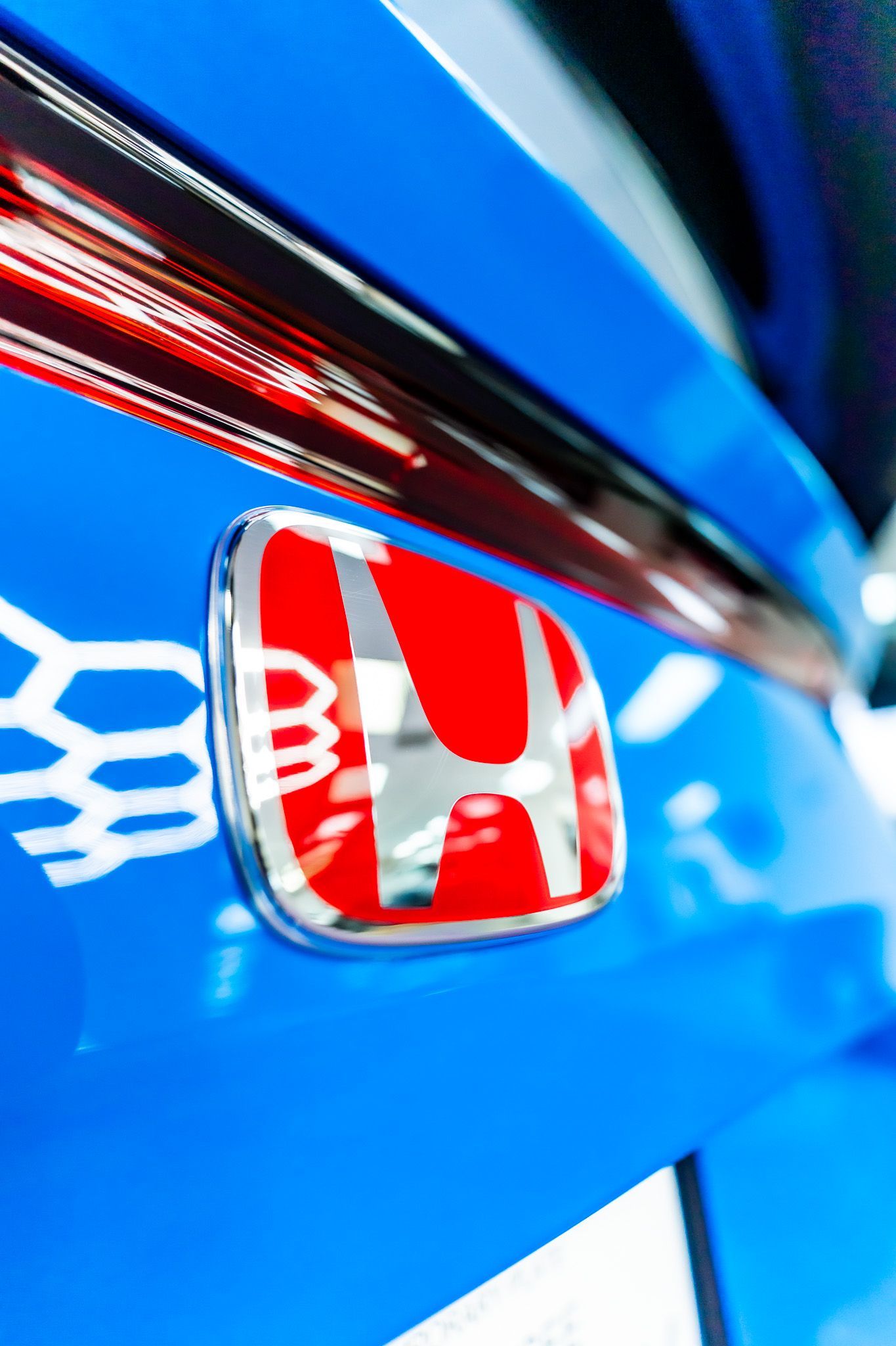 A gray truck is parked on the side of a dirt road.