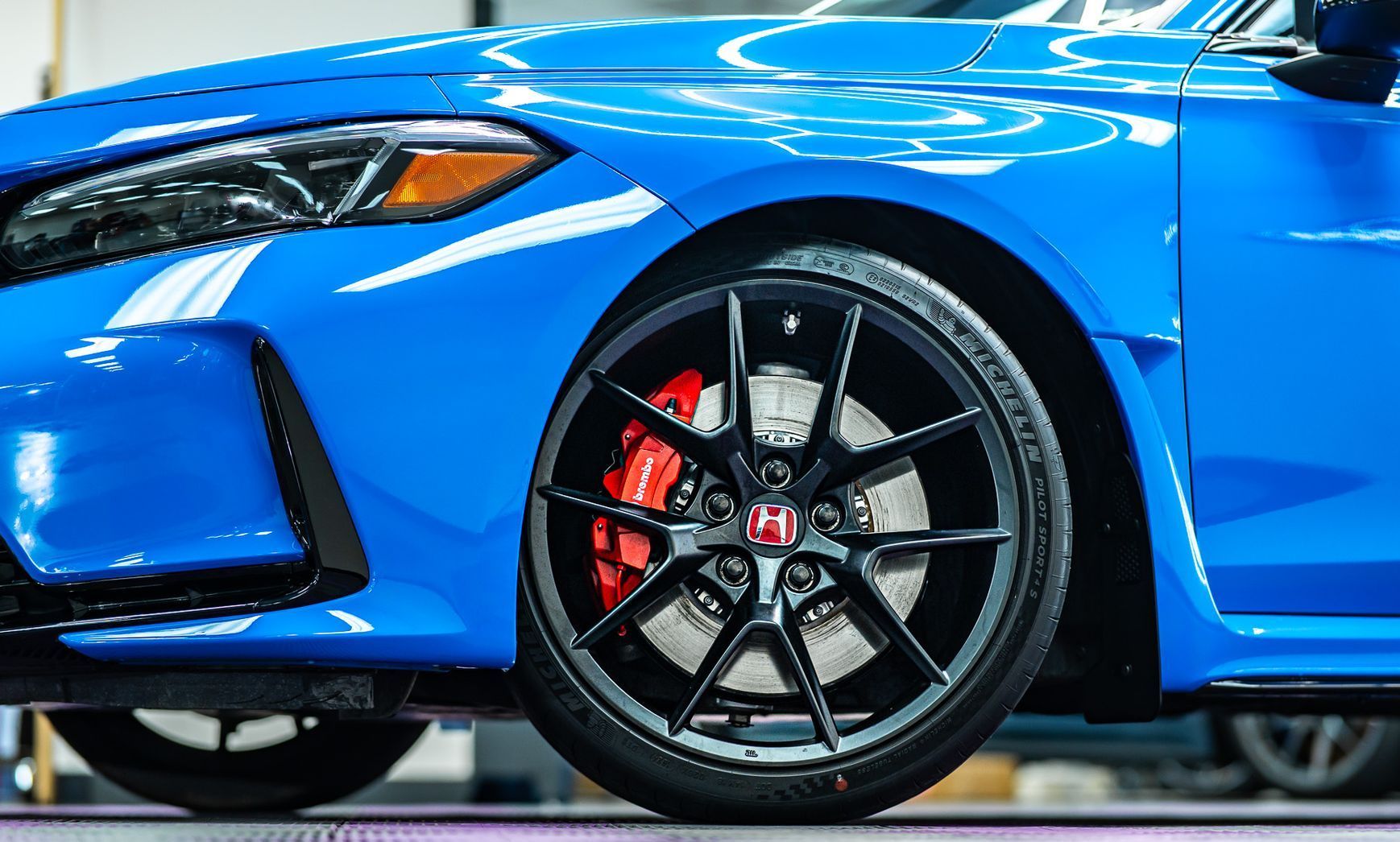 A white suv is parked in a field with a cloudy sky in the background.