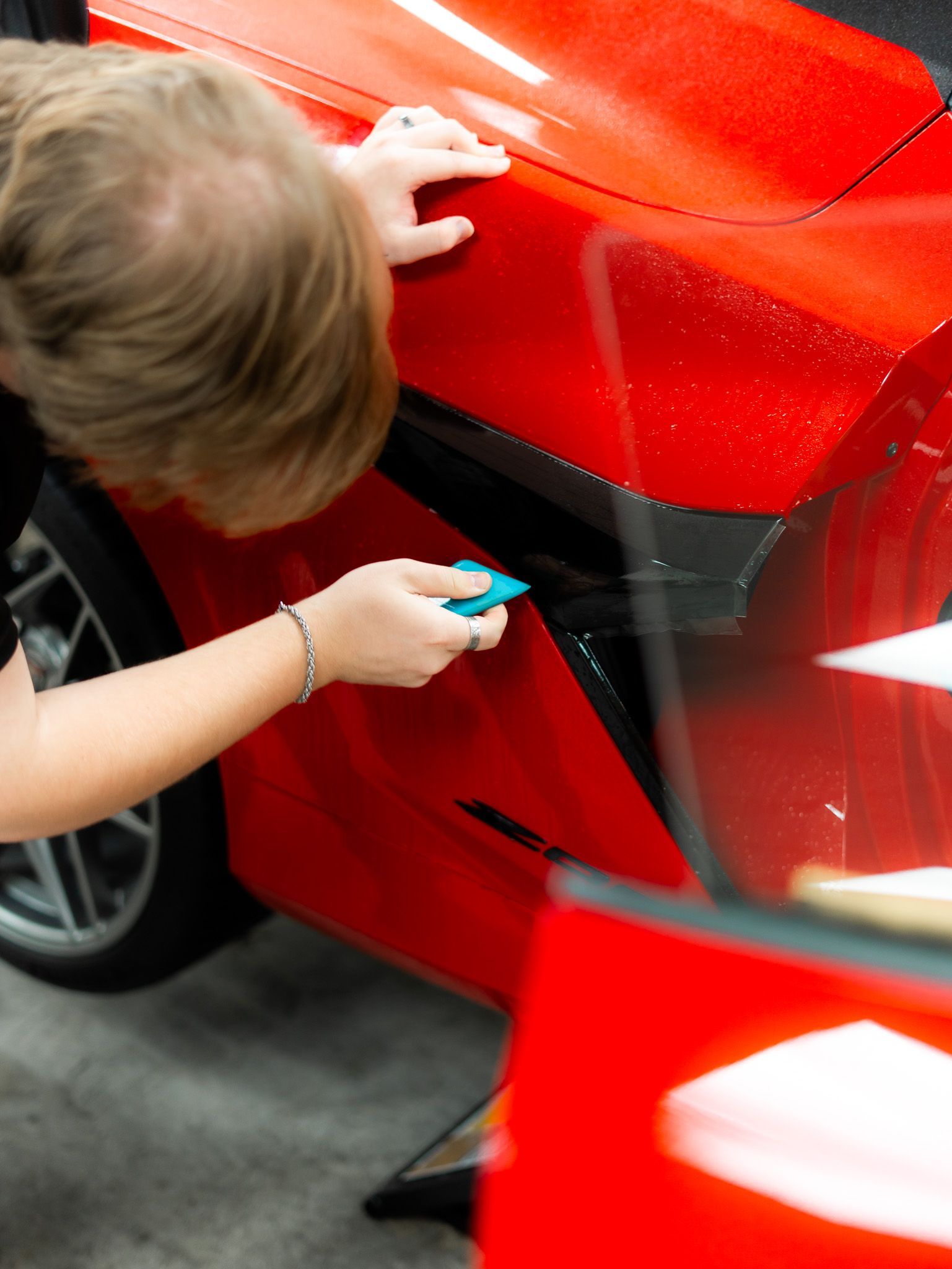 A gray truck is parked on the side of a dirt road.