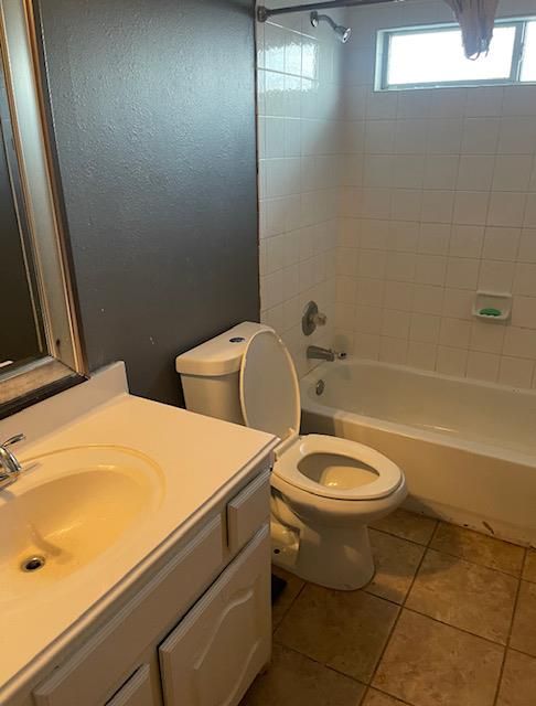 A bathroom with a toilet a sink and a bathtub