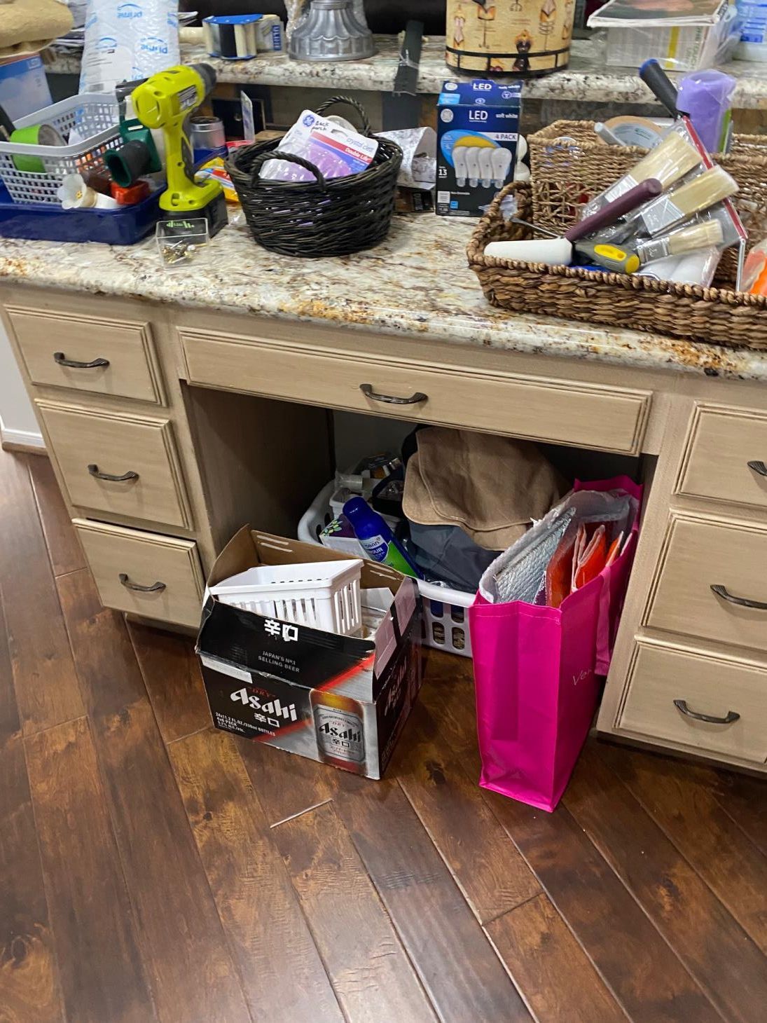 A kitchen counter with a bunch of boxes and baskets on it.