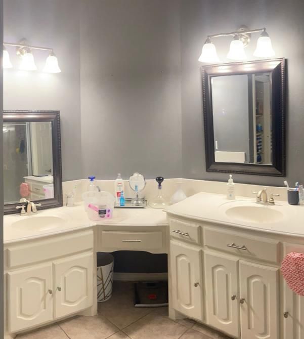 A bathroom with two sinks and two mirrors.