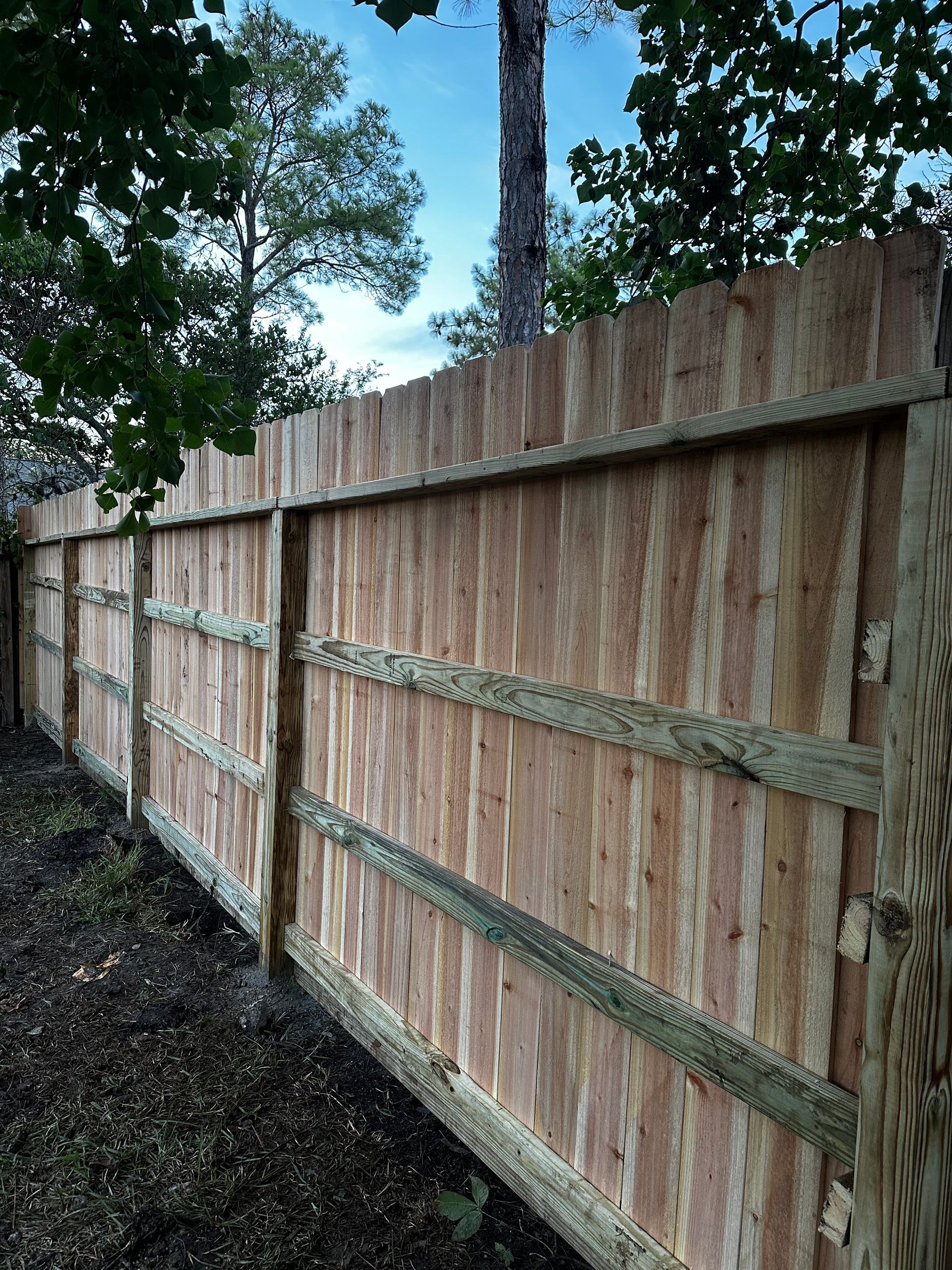 A wooden fence with trees in the background