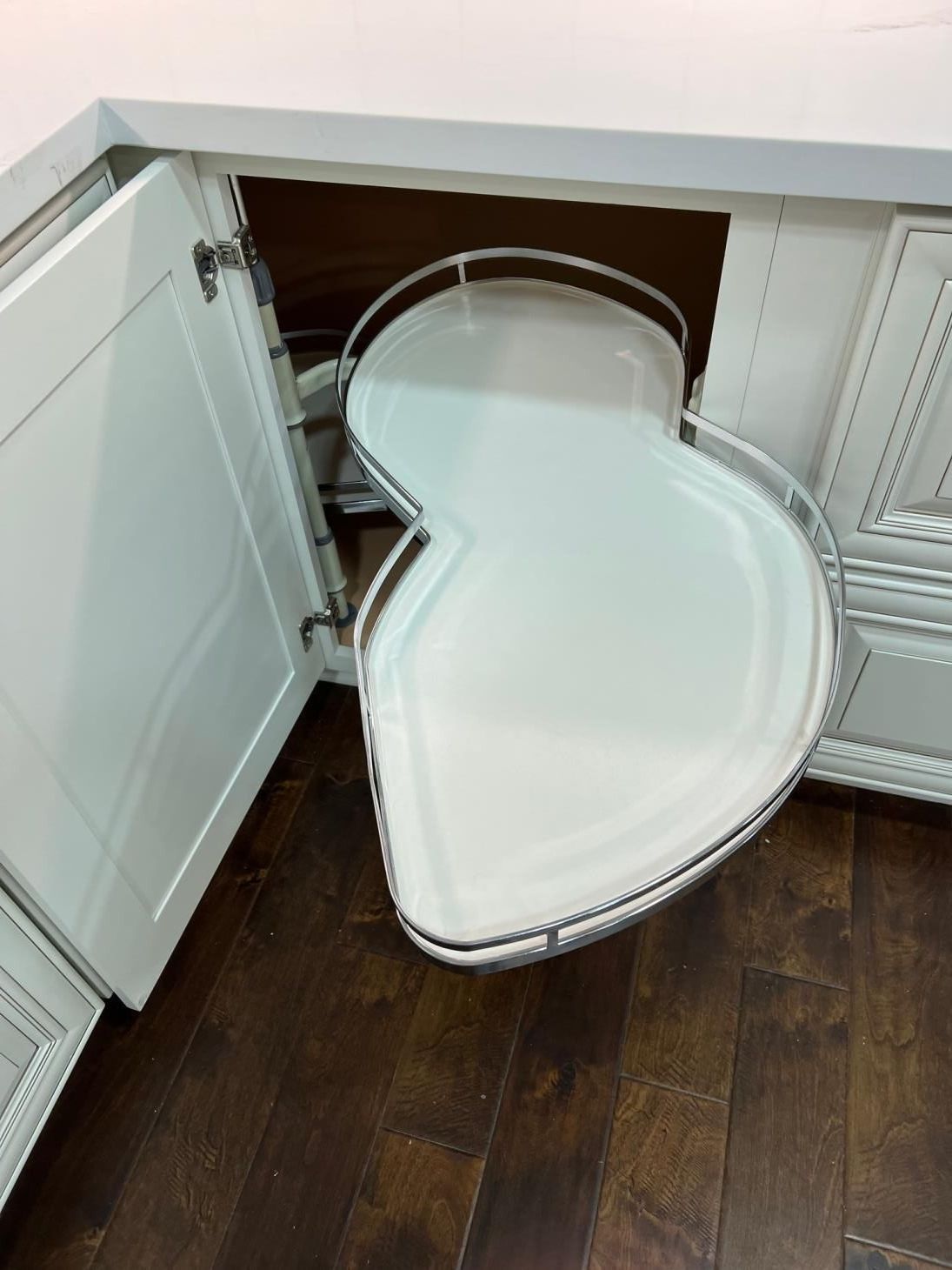 A kitchen cabinet with a corner shelf that looks like a heart.